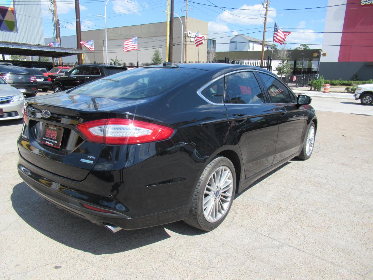 2016 Black /Black Ford Fusion SE (3FA6P0HD2GR) with an 1.5L L4 DOHC 16V engine, Automatic transmission, located at 1511 North Shepherd Dr., Houston, TX, 77008, (281) 657-1221, 29.798361, -95.412560 - 2016 FORD FUSION SE VIN: 3FA6P0HD2GR193264 3 F A 6 P 0 H D 2 G R 1 9 3 2 6 4 SEDAN 4 DR 1.5L I4 F DOHC 16V GASOLINE FRONT WHEEL DRIVE - Photo#16